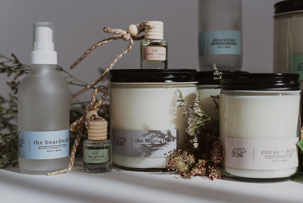 An arrangement of candles, room sprays, and car diffusers by Wick and Bear.